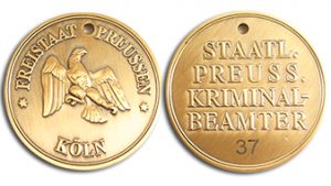 Gold-colored custom-minted movie coin with hand engraved serial number