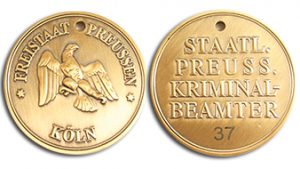 Gold-colored custom-minted movie coin with hand engraved serial number