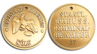 Gold-colored custom-minted movie coins with hand engraved serial number