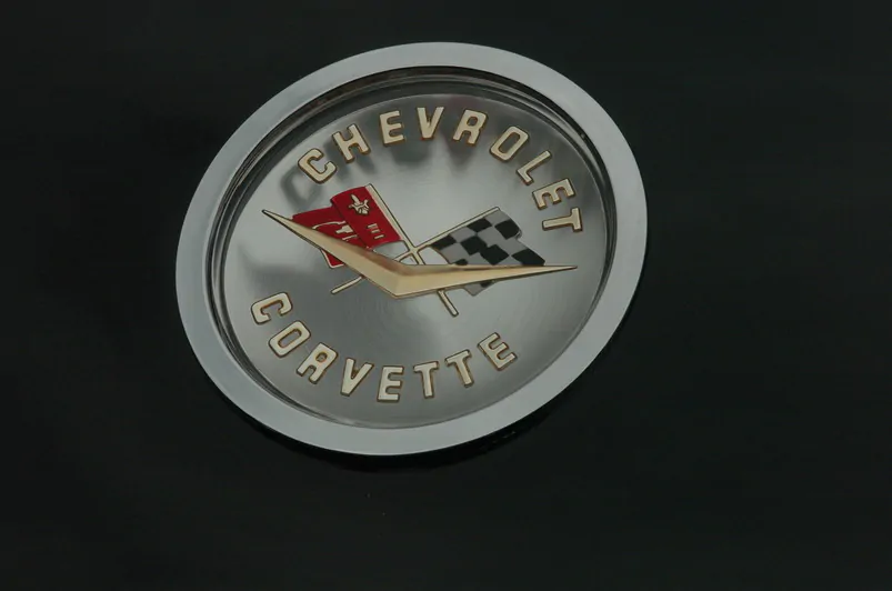 Silver custom coins for corporate celebrations. Chevrolet Corvette logo embossed on a silver coin