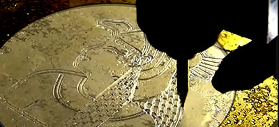 Engraving a coin Image 2